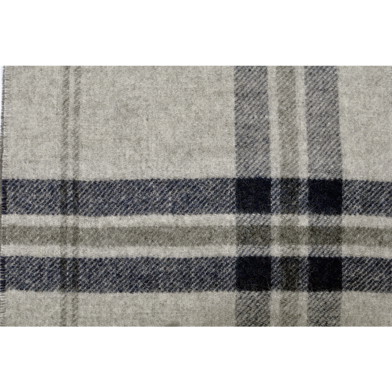 A model comfortably wearing the grey and navy plaid wool scarf, showcasing its cozy fit and everyday elegance.