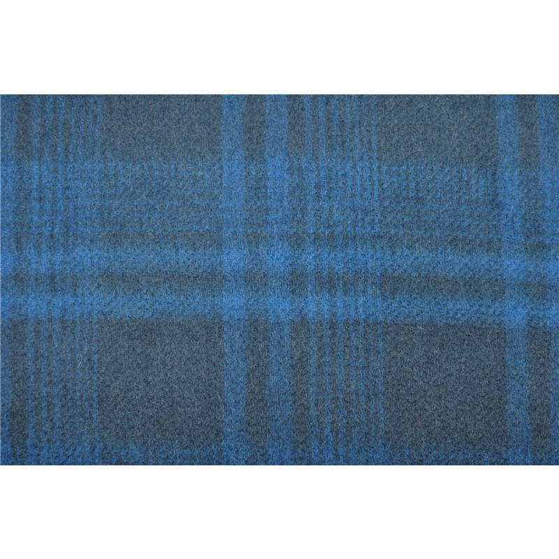 Extreme close up of the hand twisted 9cm fringes on the edge of the woven cashmere wrap