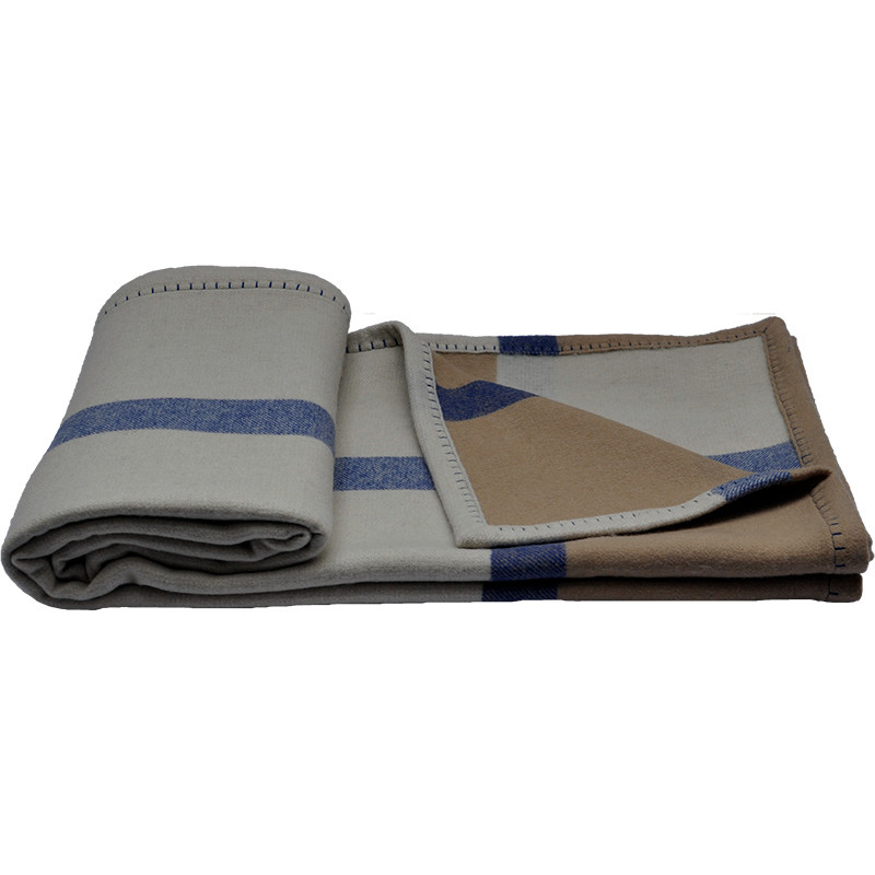 Rolled and folded Q0192-A woven lambswool bed blanket showing blue stripes, camel color blocks and decorative edge stitching.
