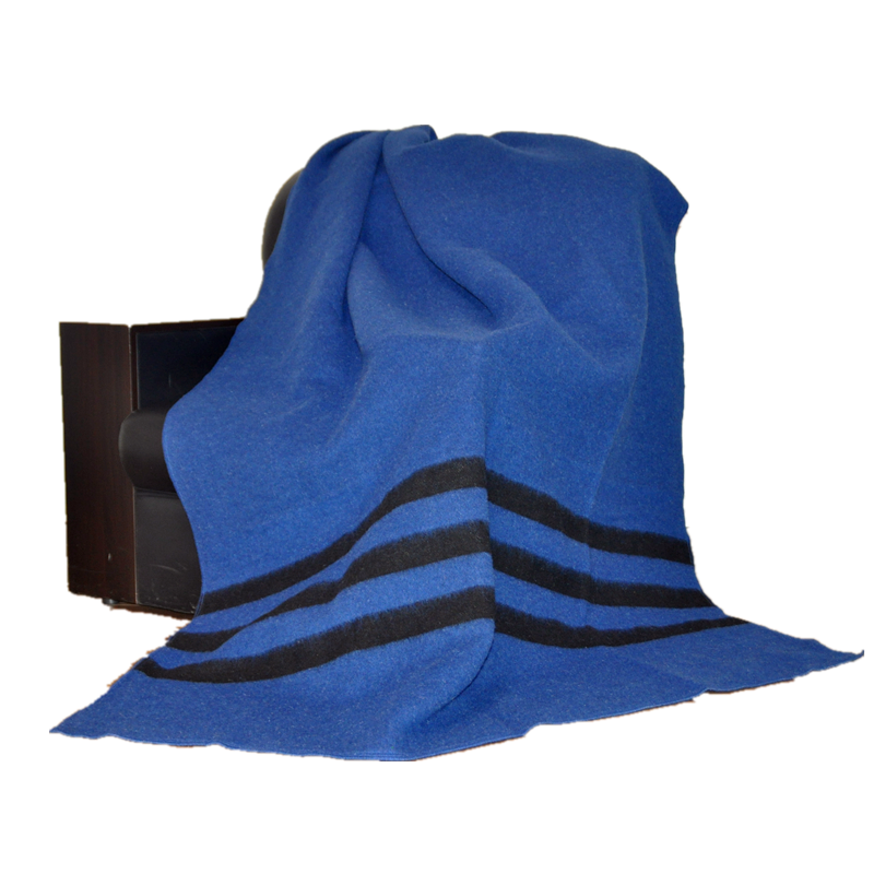 tbh2001 blue wool blend blanket, draped over an armchair, three dark stripes across the lower section