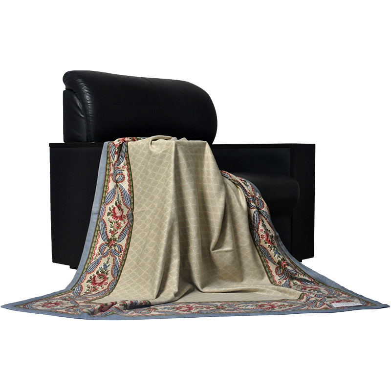 silk-floral-throw-blanket-draped-on-black-leather-sofa