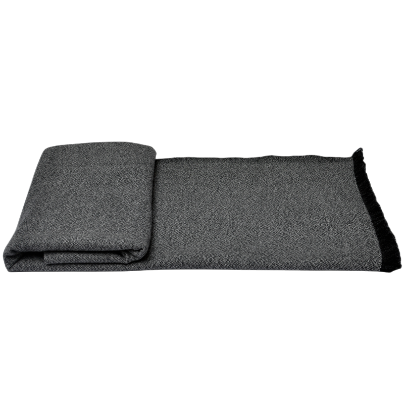 Detailed fringe and edge stitching of dark grey luxury cashmere blanket