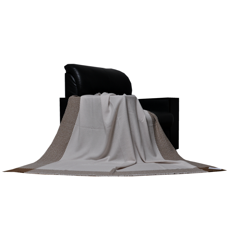 fluffy NM26/2 cashmere lambswool throw blanket draped over black leather armchair neutral home decor TAK2216