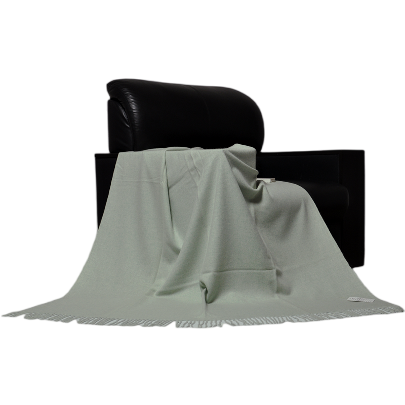 E1108 lightweight cashmere wool blanket draped over a black chair to show its soft natural drape.