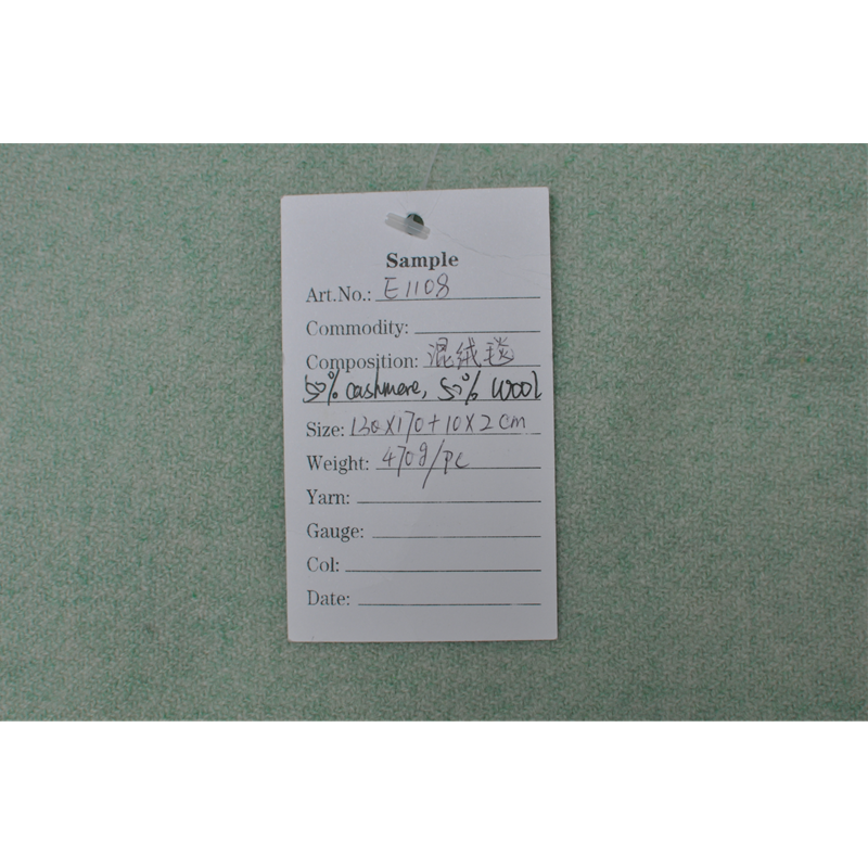 E1108 green melange cashmere wool blanket sample with product specification label.