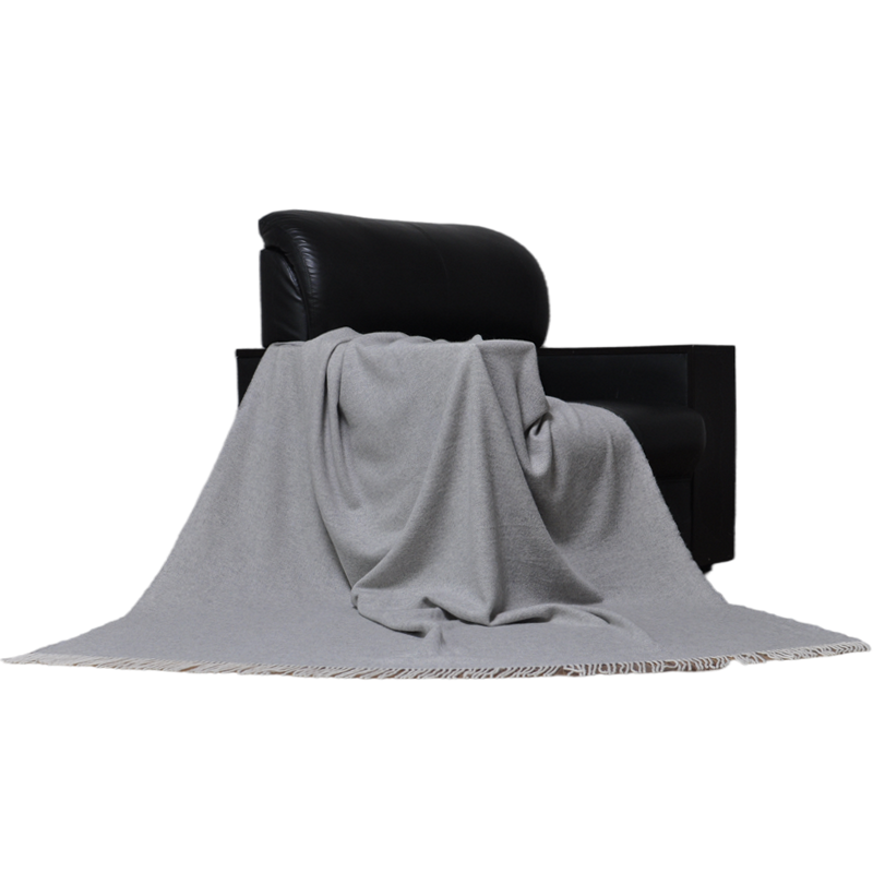 TUV1802 cashmere wool blanket draped on a modern chair creating an elegant luxury home textile atmosphere