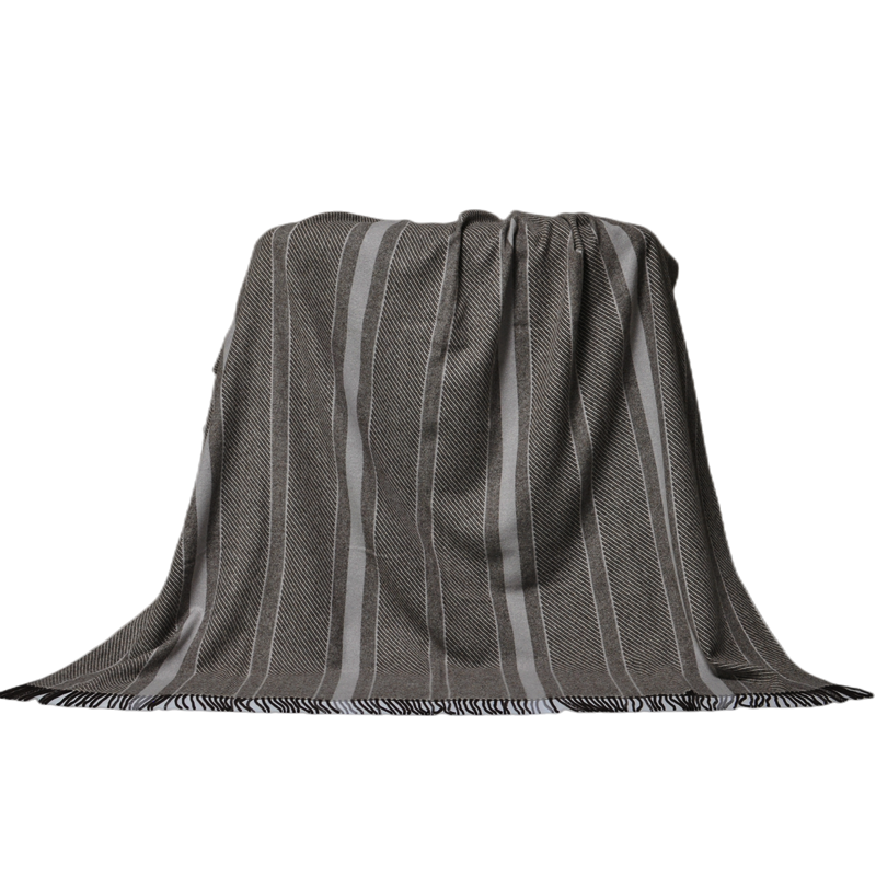 Elegant striped wool blend blanket hanging over a chair, showcase of design and drape.