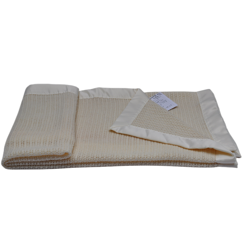 Folded natural wool blanket showing lightweight woven structure and smooth edge details