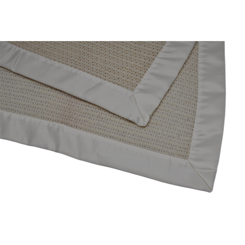 Wool blanket sample with material specification tag showing product details and textile quality