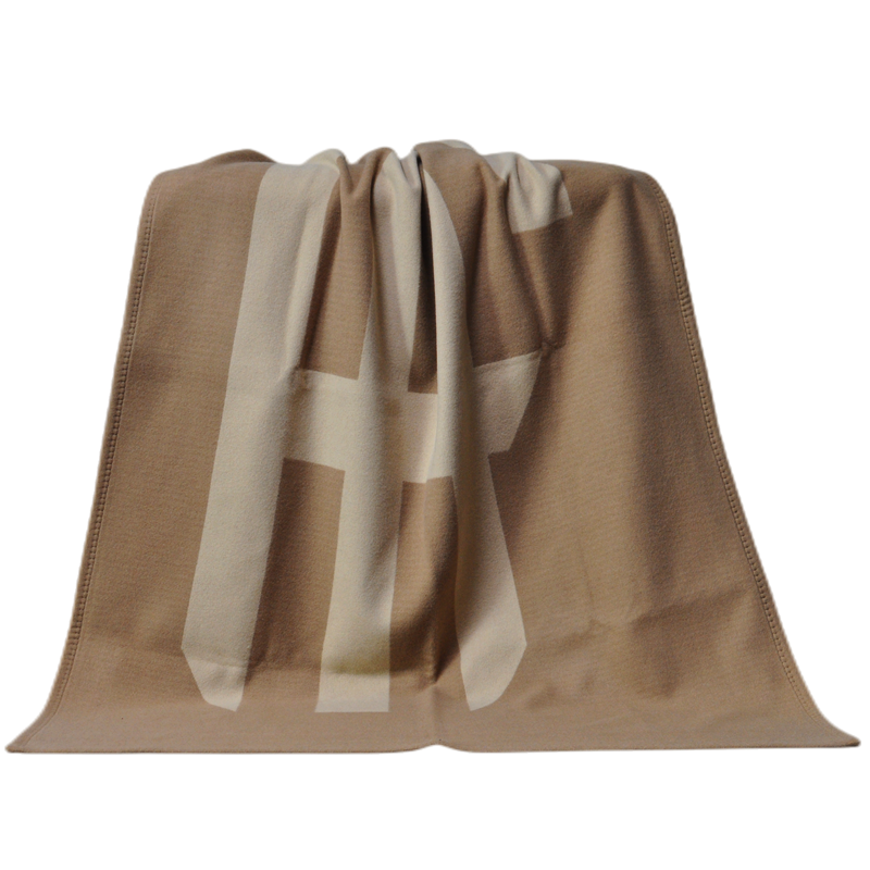 TAK2220 lamb wool cashmere blanket with custom logo pattern displayed in interior setting
