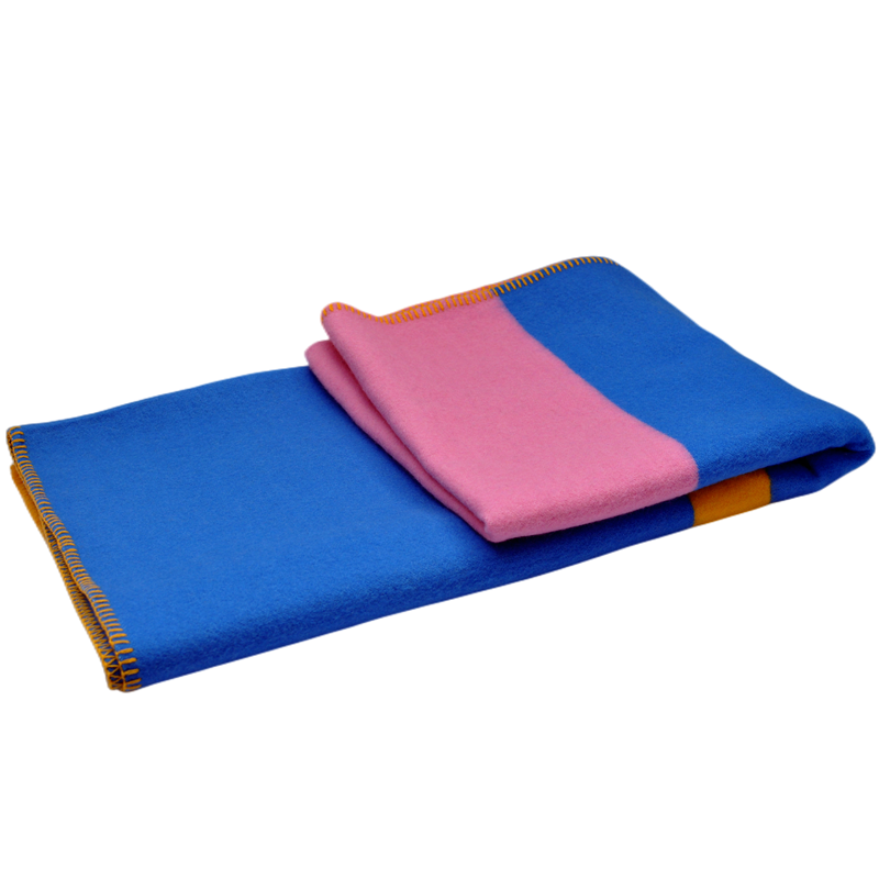 Reverse folded pink blue yellow 100% wool blanket neat stitched hem flat lay plain white background