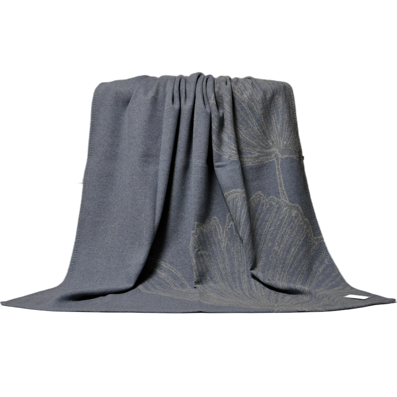 Close draped view of luxury tone-on-tone ginkgo wool throw, soft draping fabric texture