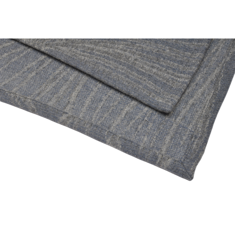 Closeup neat stitched hem edge detail of 100% wool throw blanket