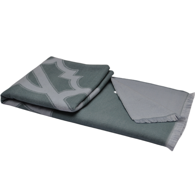 TDX2203 grey-green geometric patterned throw blanket with tasseled edges.