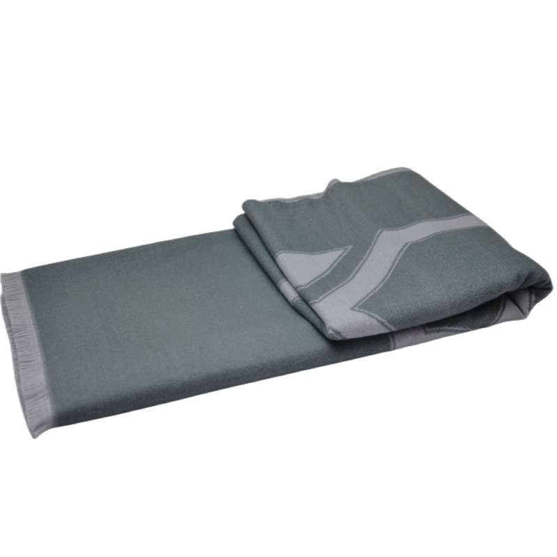 Folded view of the TDX2203 grey-green geometric patterned throw blanket showcasing its texture