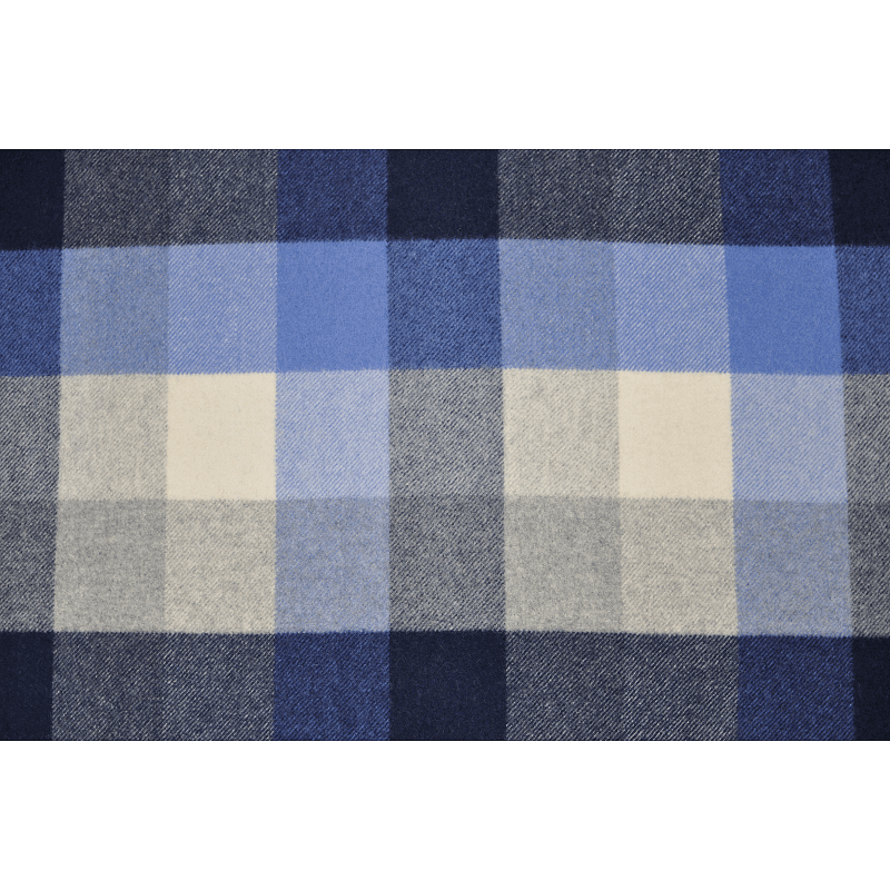 Full front view of K1003 blue tartan plaid wool blanket showcasing its atmospheric checkered design for retail brand line
