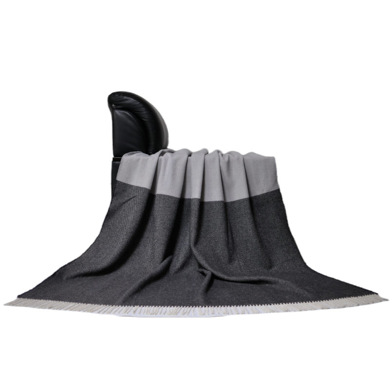 Wool color block throw blanket draped on leather armchair