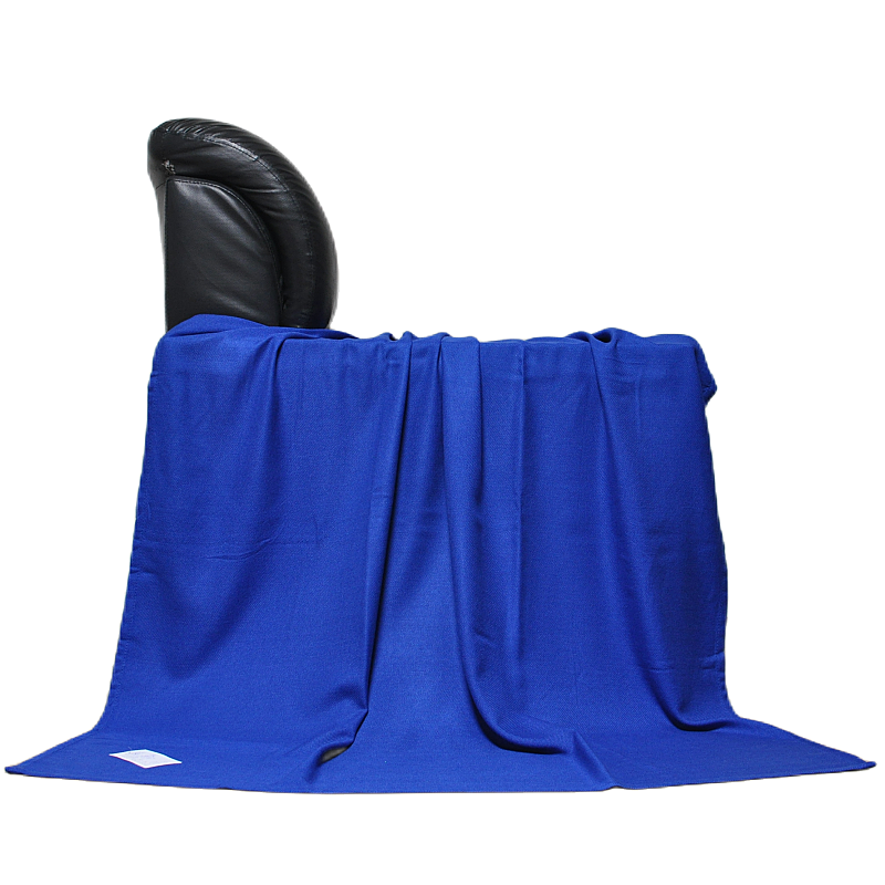 Fire resistant airline blanket laid over lounge chair for travel