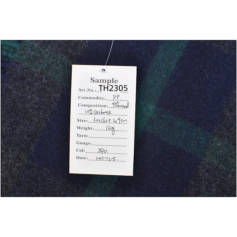Lifestyle shot of blue grey green plaid scarf
