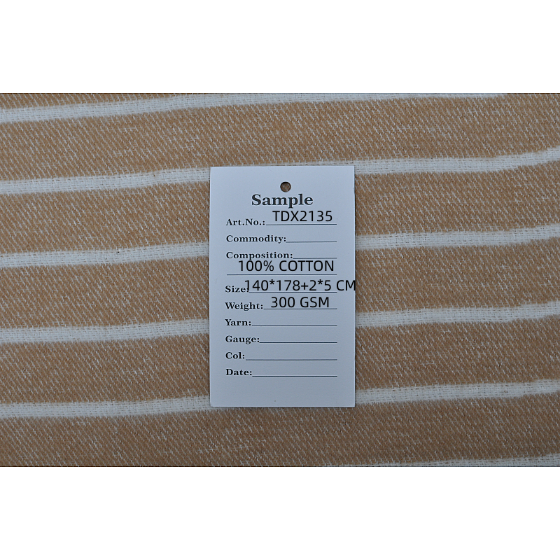 100% organic cotton throw blanket TDX2135 camel and white mélange fabric texture with product tag, view 9