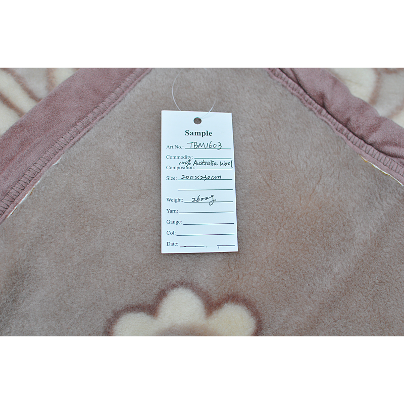 Official product sample tag for TBM1603 showing 100% Australia wool and 200x230cm size