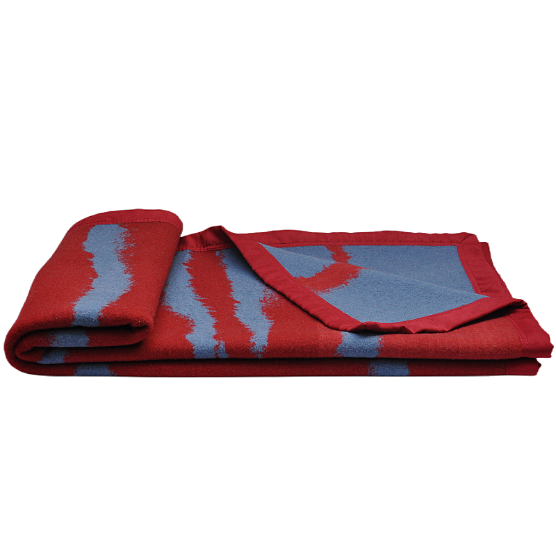 Flat-folded 100% wool throw blanket with red and grey irregular wave pattern.