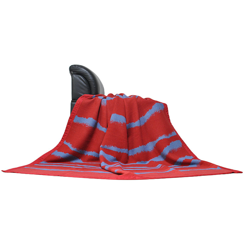 Side profile view of a red and grey wool blanket draped over furniture.