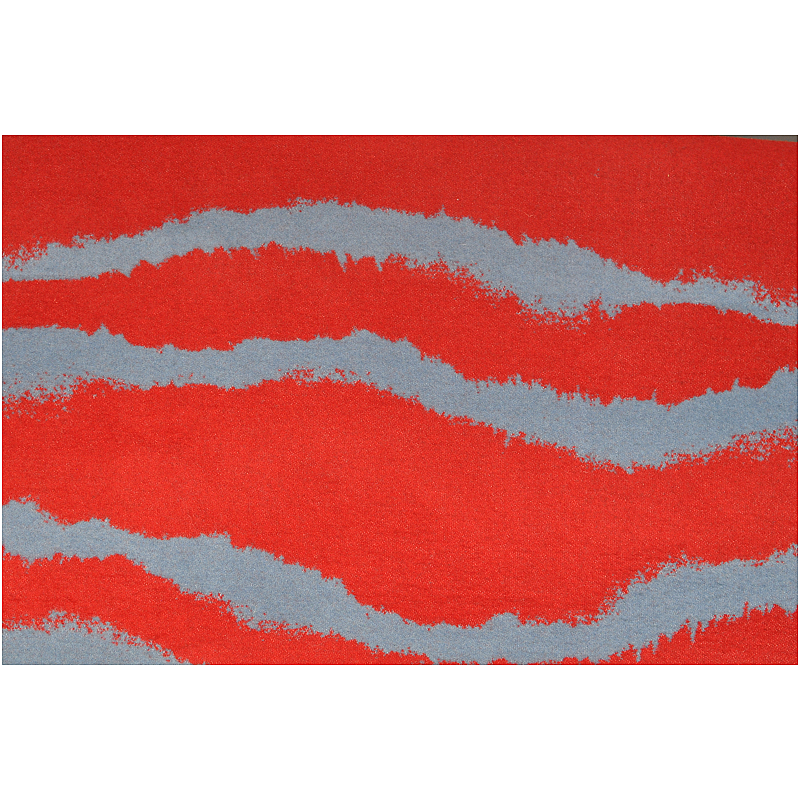 Close-up of the red and grey irregular wave pattern on the wool blanket.