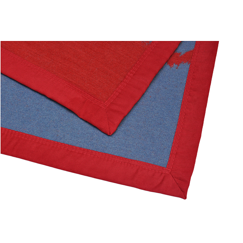 Detail of the red suede-bound edge on a wool blanket.