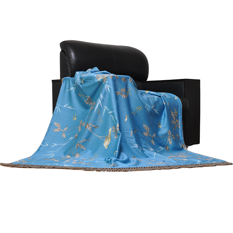 Silk floral tassel throw blanket draped on black leather sofa style 1