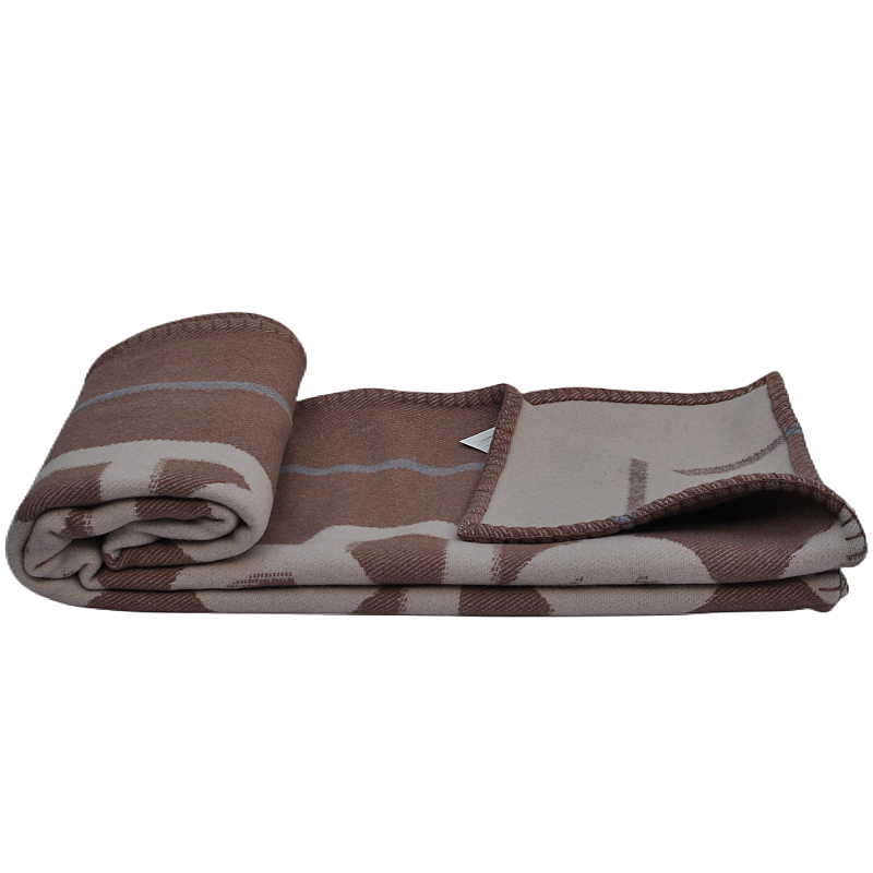 TAK2260 heavyweight lambswool blanket folded with geometric jacquard pattern and decorative stitched edge