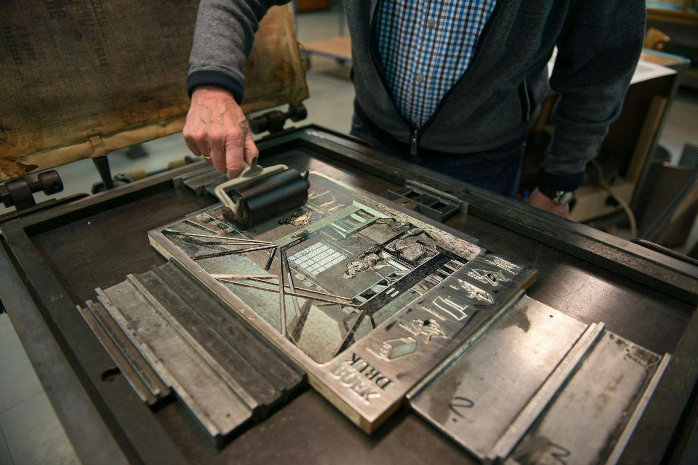 A man using an old inkjet printer
