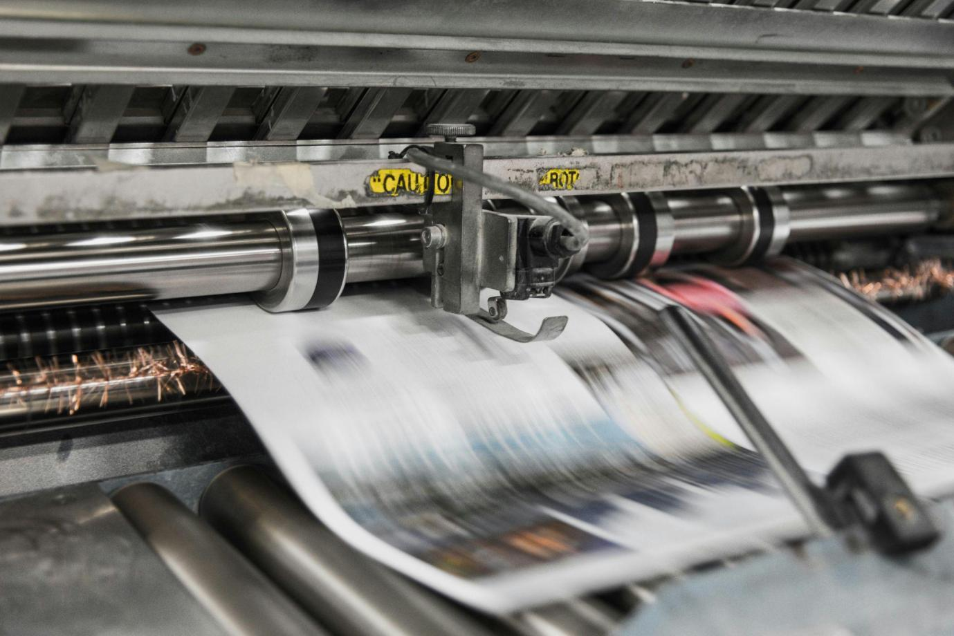 A close-up view of a printing machine in operation, showcasing the intricate details and mechanisms.